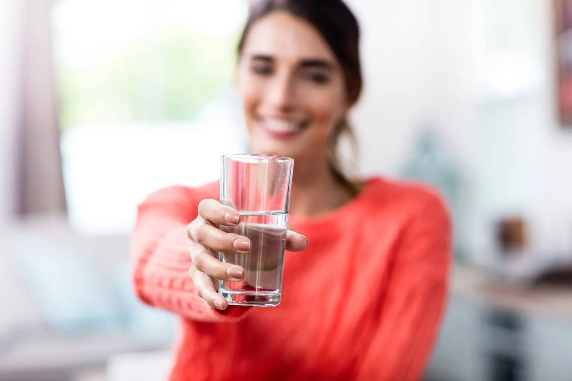 person holding water glass
